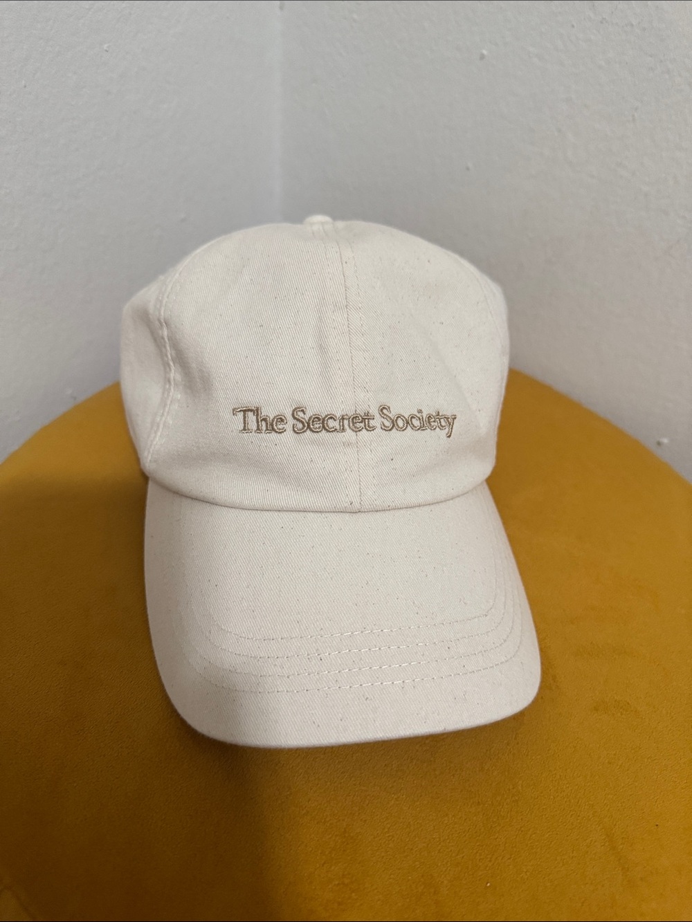 Mango Cream Baseball Cap with Embroidered 'The Secret Society' Logo